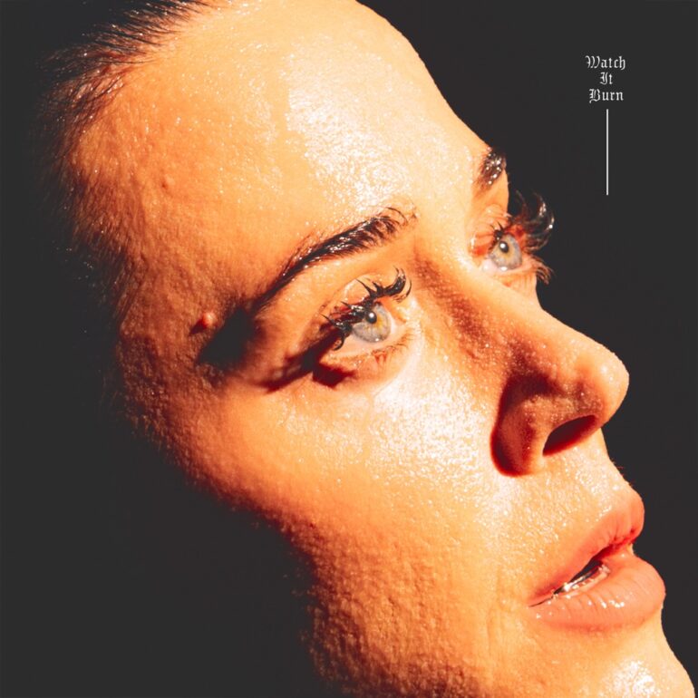 Album cover: close-up of a woman's glistening face tilted upward with the title 'Watch It Burn' in the corner.