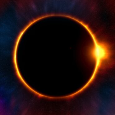 Solar eclipse with a bright orange corona around a dark disk, against a starry space background.