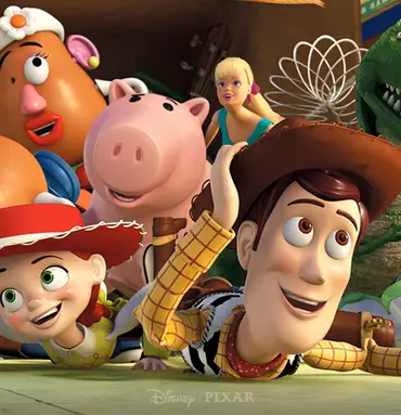 Woody, Buzz Lightyear, Jessie and a colorful group of Toy Story characters lie on the floor, smiling and peeking toward the camera.