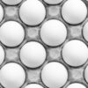 Close-up of white eggs neatly arranged in a gray egg carton in grayscale.