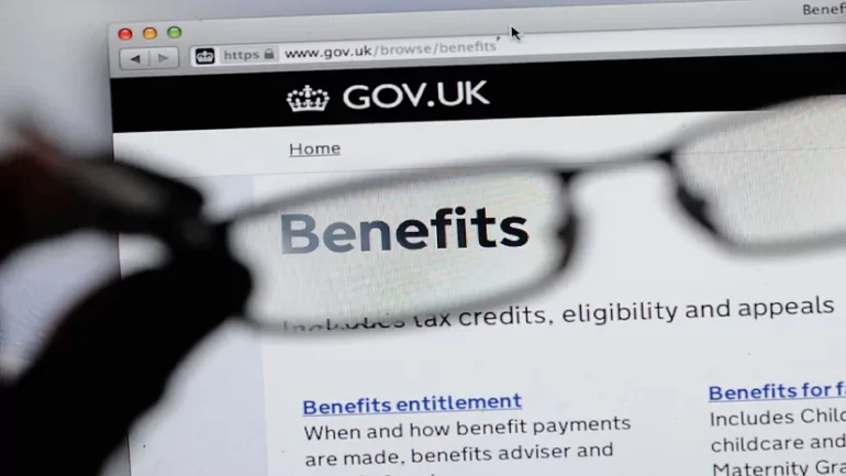 Close-up of a browser showing the GOV.UK Benefits page, with a pair of glasses held in front of the screen.