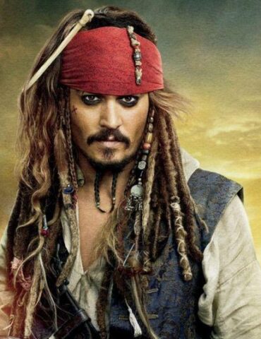 Captain Jack Sparrow in a red bandana and pirate outfit, standing in a smoky harbor with ships in the background