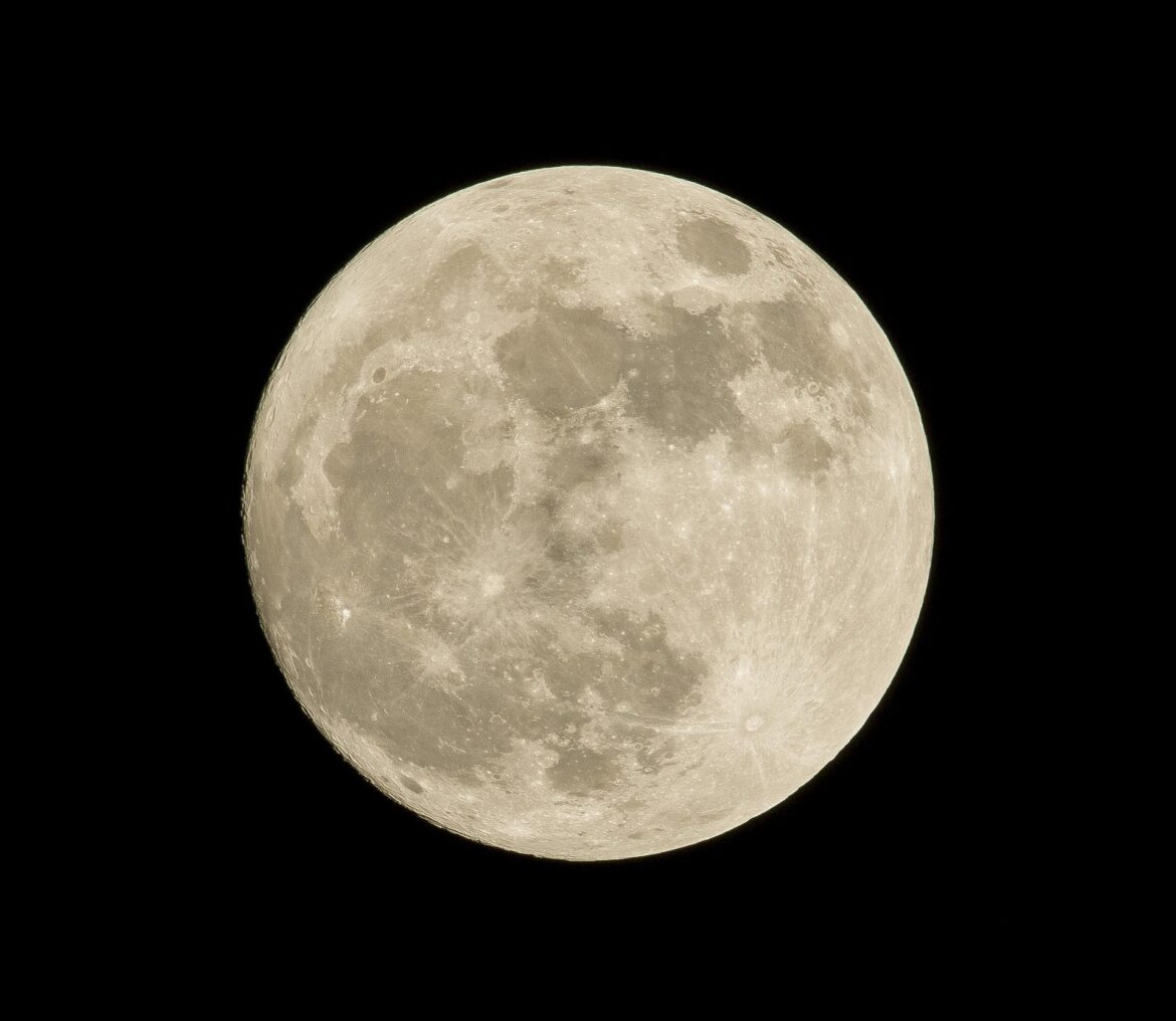 Close-up view of the Moon's cratered surface against a black sky; details of craters and maria visible throughout the disk.