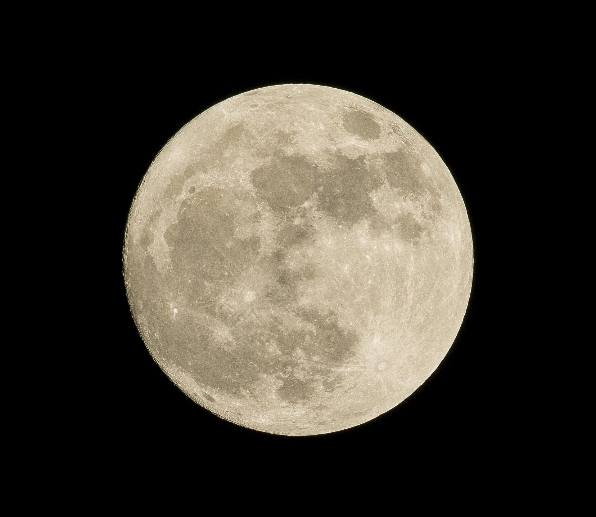 Close-up view of the Moon's cratered surface against a black sky; details of craters and maria visible throughout the disk.