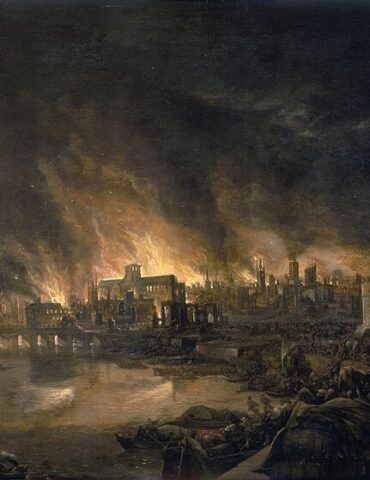Night scene of a city on fire by the river, with a stone bridge and fortified walls in the distance.