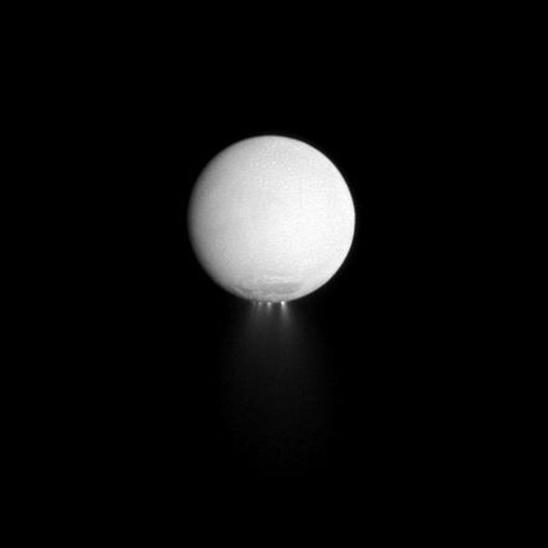White sphere resting on a dark surface with subtle light rays beneath it, against a black background.