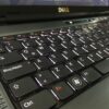 Close-up of a black Dell laptop keyboard, showing Caps Lock (Bloq Mayús), Ctrl, Fn, and Windows keys with subtle backlighting.