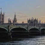 London's Westminster Bridge with the Palace of Westminster and Big Ben at sunset along the Thames.
