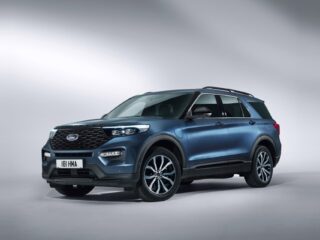 Blue Ford SUV shown in a studio setting from a front three-quarter view, highlighting its grille, headlights, and alloy wheels.